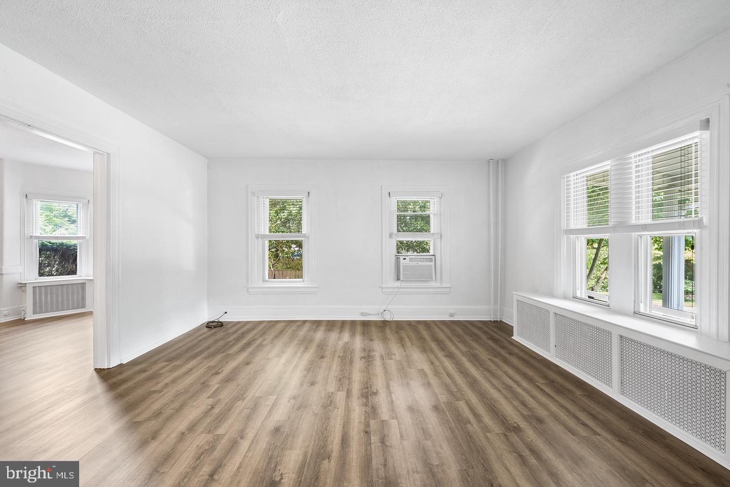 322 Conshohocken State Road Gladwyne, PA 19035 - Photo 11 of 31 an empty room with wooden floor and windows