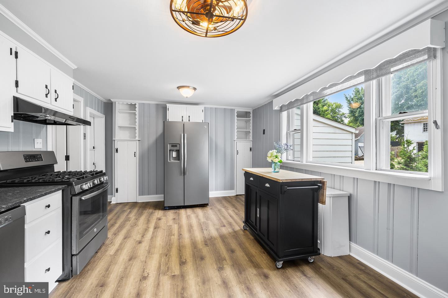 322 Conshohocken State Road Gladwyne, PA 19035 - Photo 18 of 31 a kitchen with stainless steel appliances granite countertop a stove a refrigerator a sink and dishwasher with wooden floor
