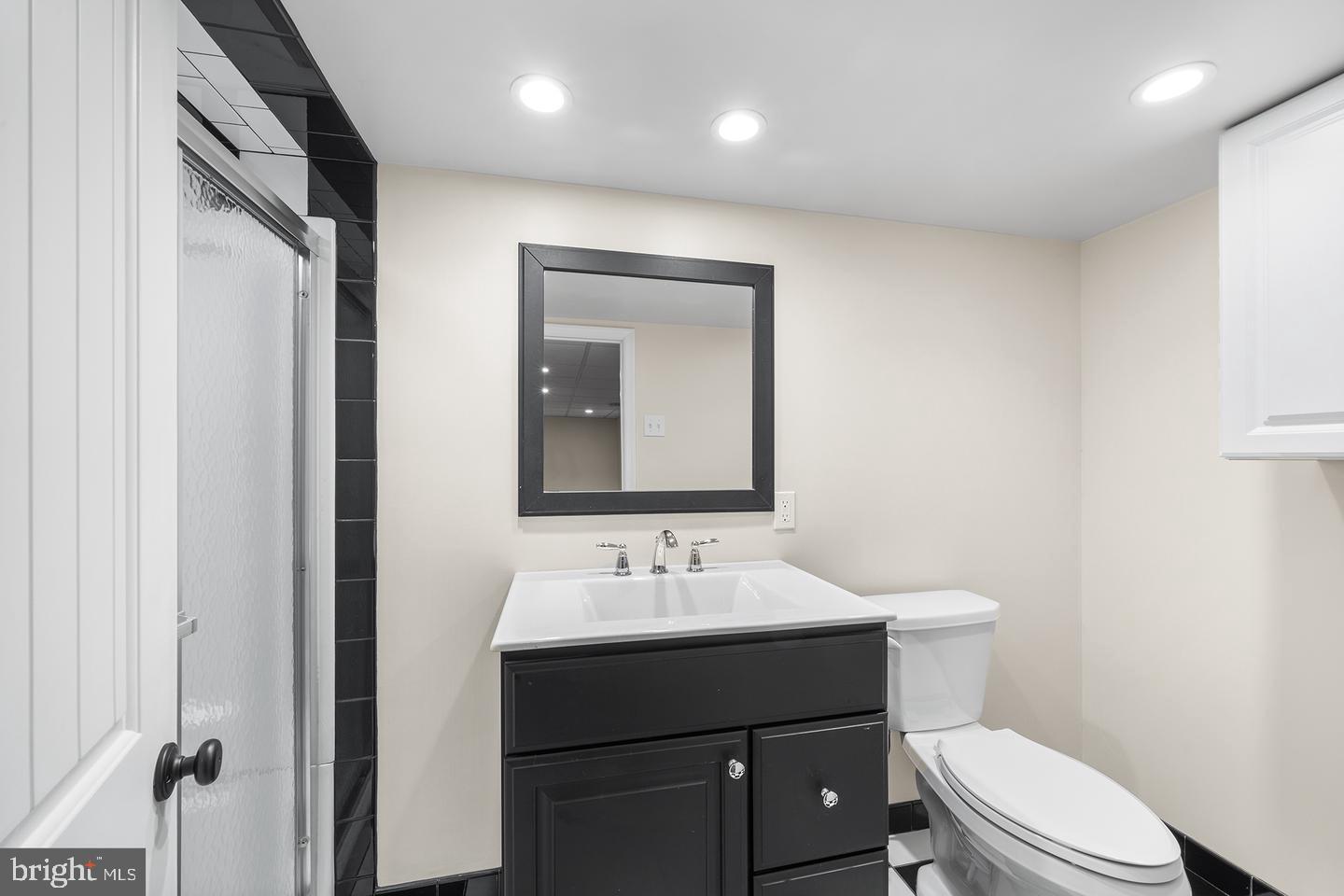 322 Conshohocken State Road Gladwyne, PA 19035 - Photo 30 of 31 a bathroom with a sink a toilet a mirror and vanity