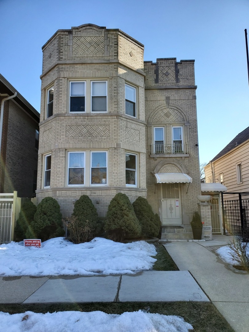 5135 West Roscoe Street, Unit B Chicago, IL 60641 - Photo 1 of 12 a front view of a house with a yard