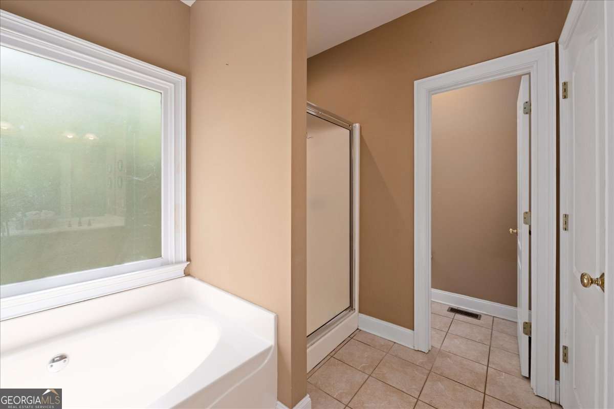 71 Staghorn Trail Nicholson, GA 30565 - Photo 12 of 32 a bathroom with a bathtub and a shower