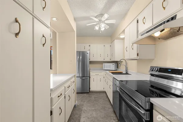 a kitchen with cabinets and stainless steel appliances