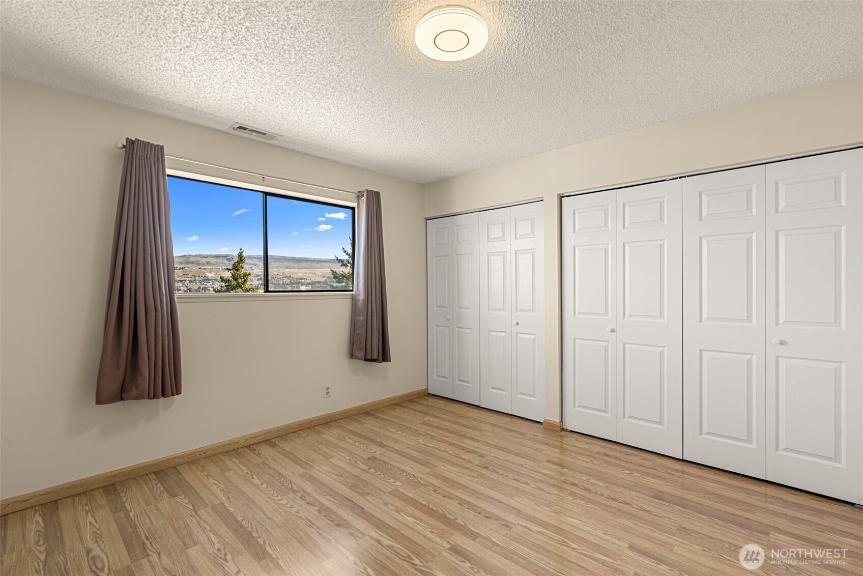 407 Oregon Street, Unit 231 Wenatchee, WA 98801 - Photo 17 of 31 a view of empty room with wooden floor