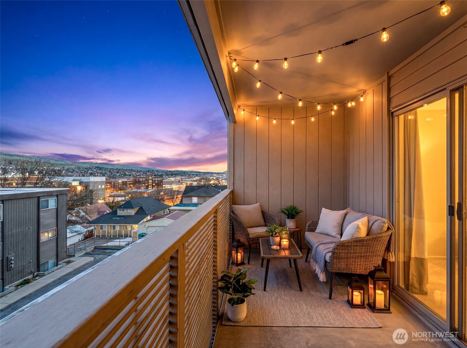 407 Oregon Street, Unit 231 Wenatchee, WA 98801 - Photo 2 of 31 a balcony with outdoor seating and city view