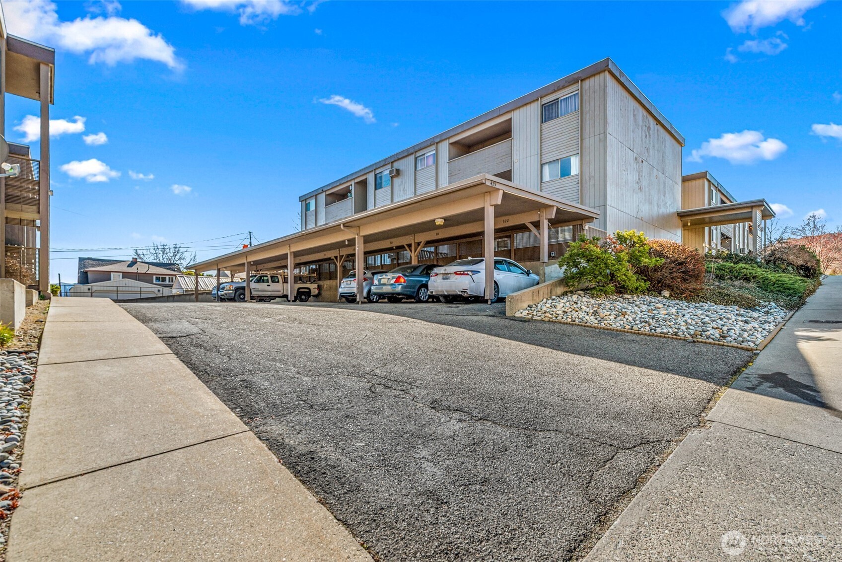 407 Oregon Street, Unit 231 Wenatchee, WA 98801 - Photo 30 of 31 a front view of house with a yard and potted plants