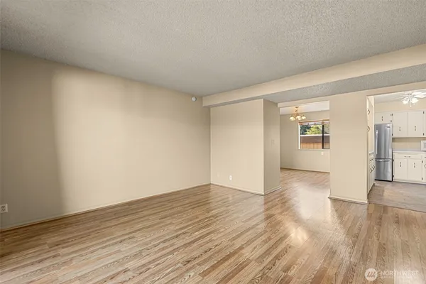 a view of an empty room and wooden floor