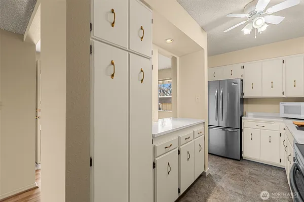 a kitchen with white cabinets and stainless steel appliances