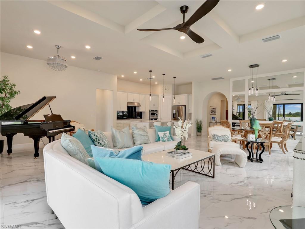 19724 Aqua View Lane Fort Myers, FL 33913 - Photo 10 of 44 a living room with furniture kitchen view and a chandelier