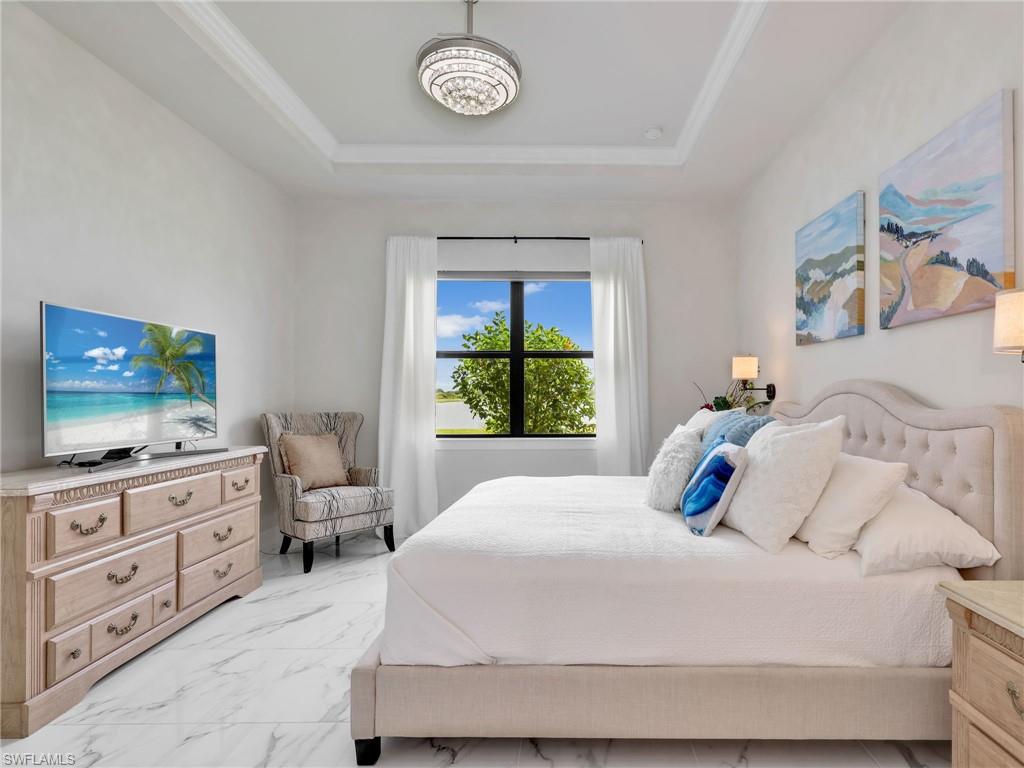 19724 Aqua View Lane Fort Myers, FL 33913 - Photo 17 of 44 a bedroom with a bed and a flat screen tv