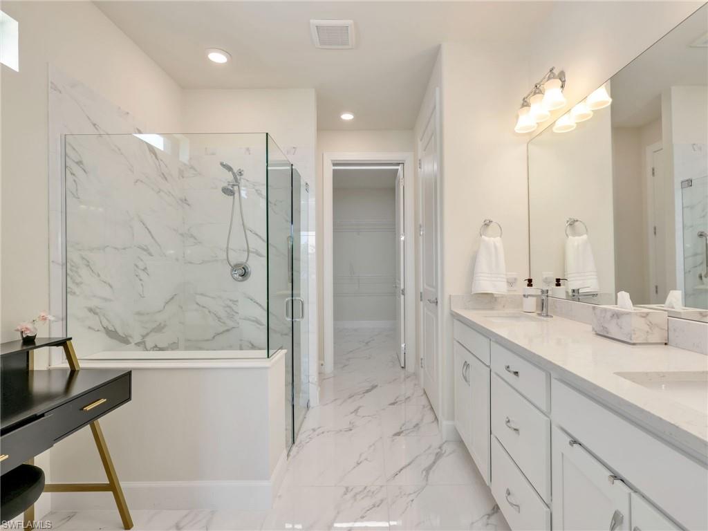 19724 Aqua View Lane Fort Myers, FL 33913 - Photo 19 of 44 a bathroom with a double vanity sink mirror and shower