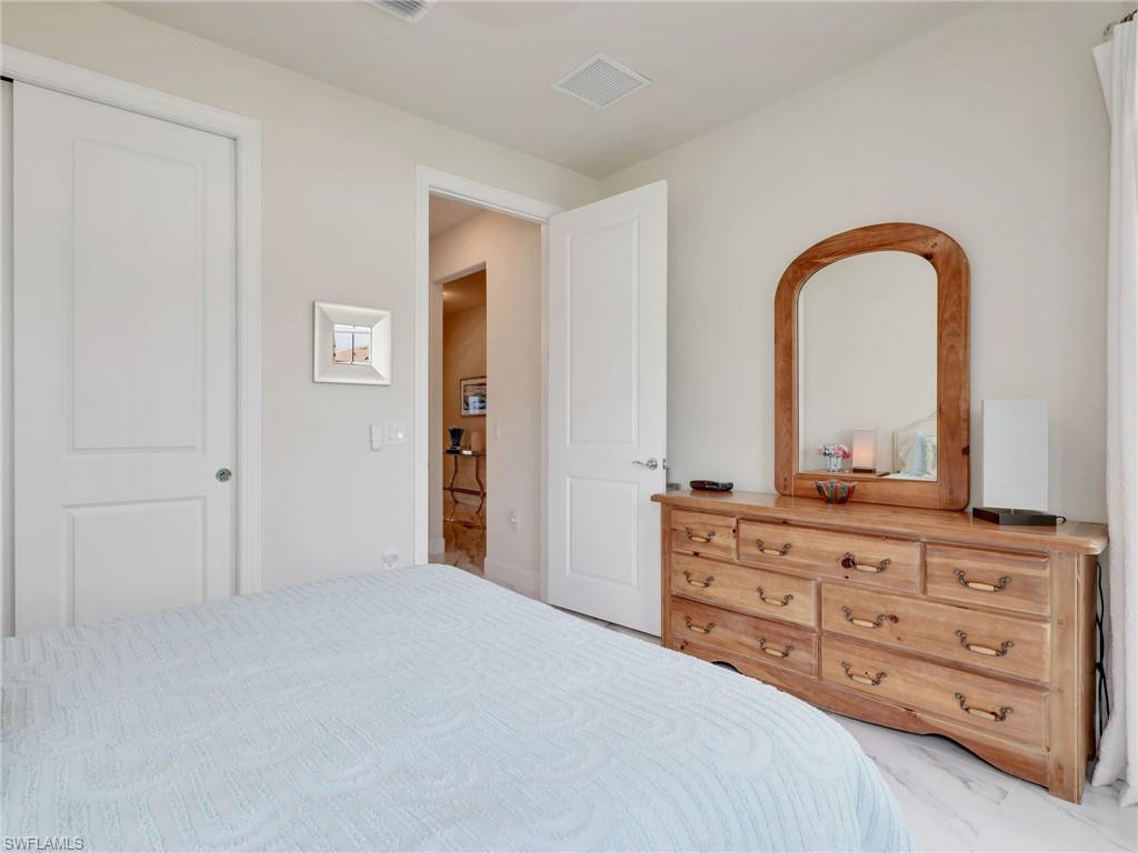 19724 Aqua View Lane Fort Myers, FL 33913 - Photo 23 of 44 a bedroom with a bed and a dresser