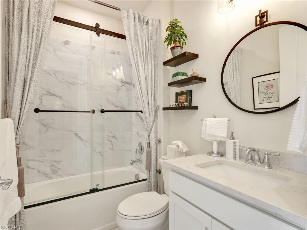 19724 Aqua View Lane Fort Myers, FL 33913 - Photo 24 of 44 a bathroom with a sink a toilet and shower