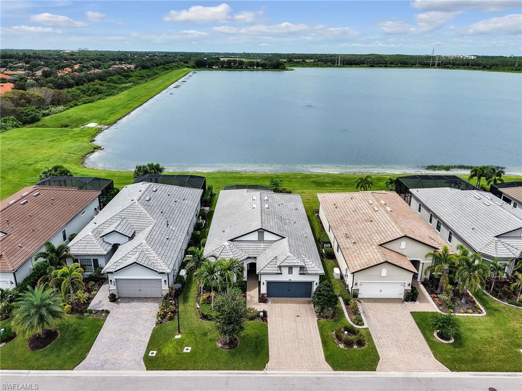 19724 Aqua View Lane Fort Myers, FL 33913 - Photo 38 of 44 an aerial view of a house with a garden and lake view