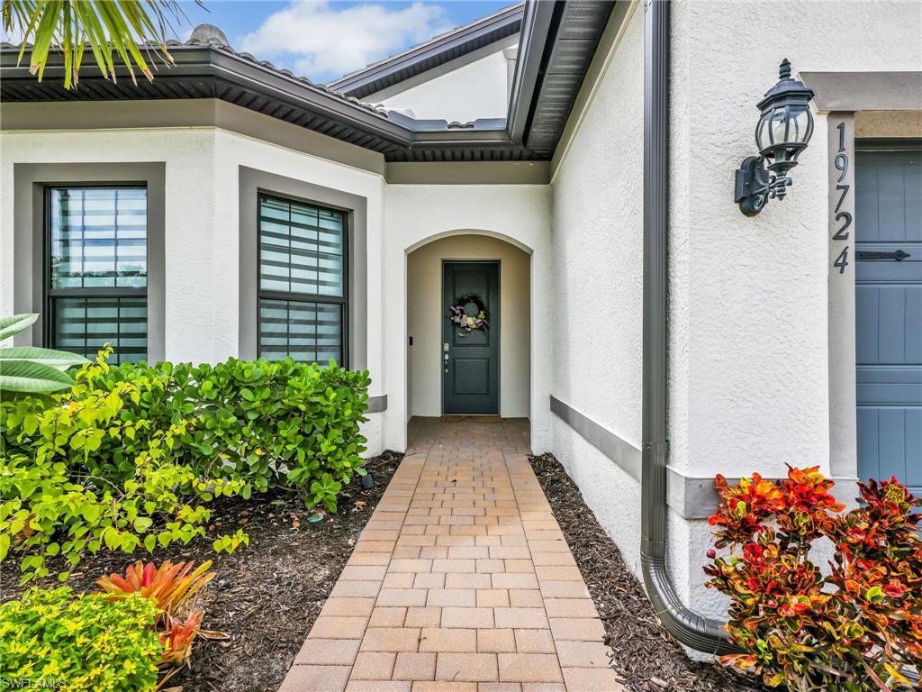 19724 Aqua View Lane Fort Myers, FL 33913 - Photo 4 of 44 a view of a pathway with a flower garden