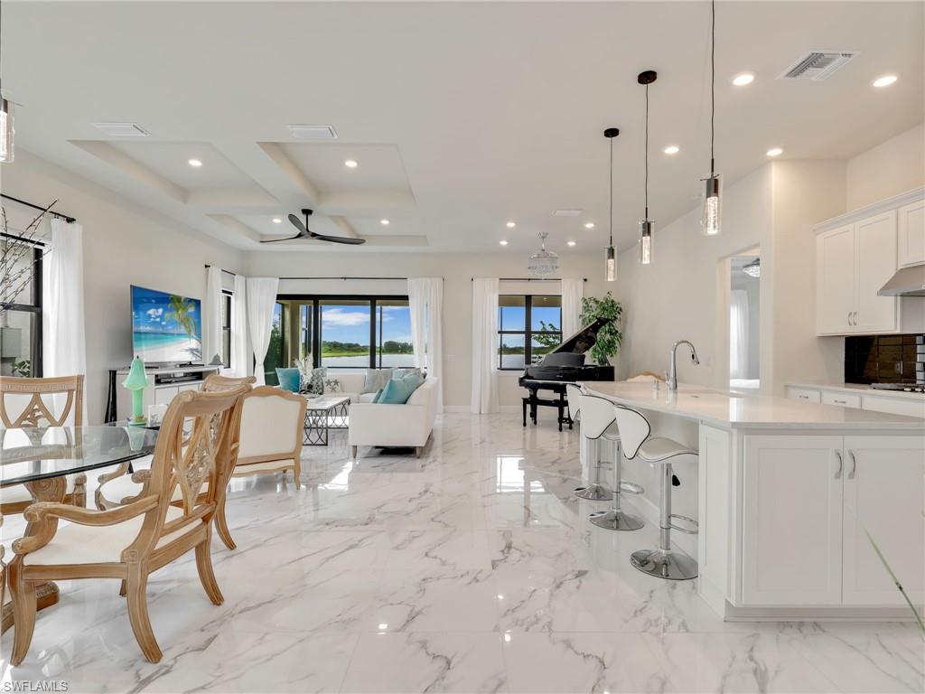 19724 Aqua View Lane Fort Myers, FL 33913 - Photo 43 of 44 a view of kitchen with dining table and chairs