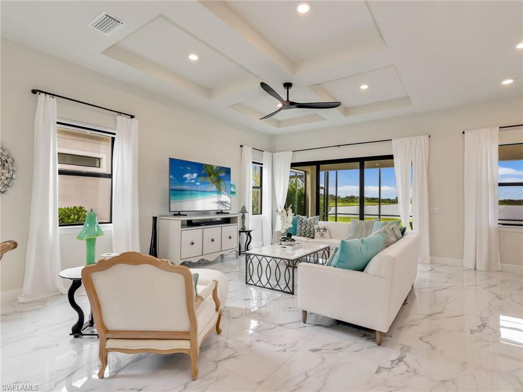 19724 Aqua View Lane Fort Myers, FL 33913 - Photo 8 of 44 a living room with furniture and a flat screen tv