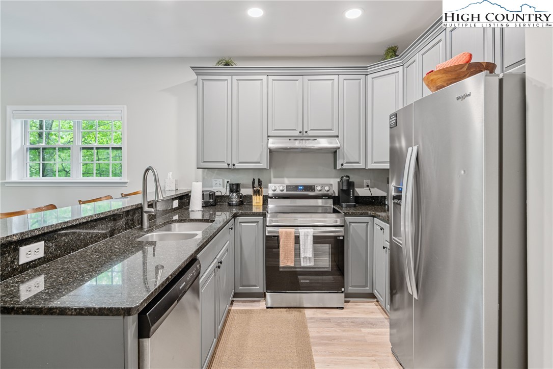 170 Inn At Crestwood Drive Boone, NC 28607 - Photo 11 of 33 a kitchen with granite countertop a refrigerator stove and sink