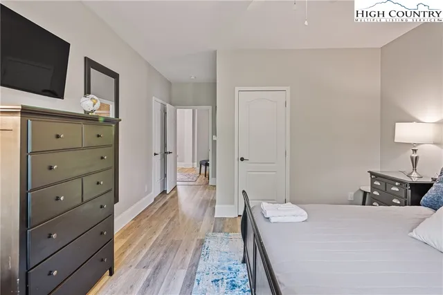 a bedroom with a bed and flat screen tv