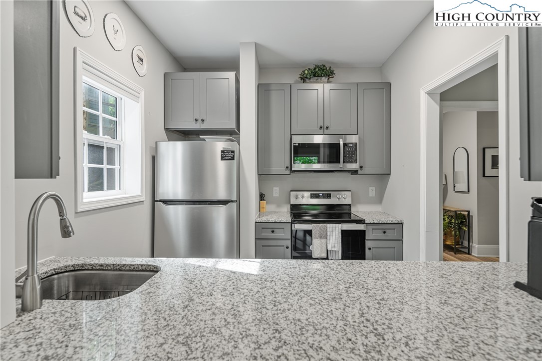 170 Inn At Crestwood Drive Boone, NC 28607 - Photo 25 of 33 a kitchen with granite countertop a refrigerator stove and sink