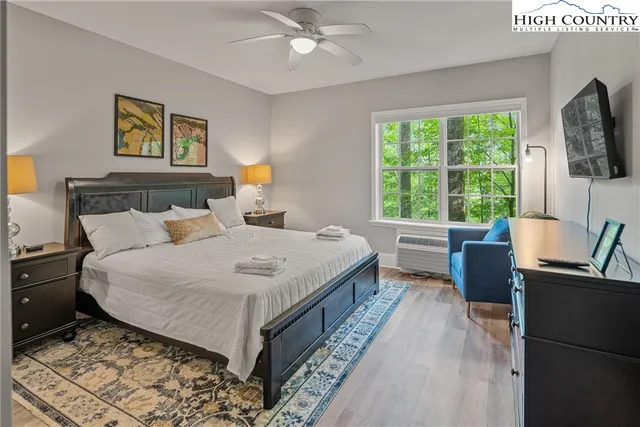 a bedroom with a large bed and a flat screen tv