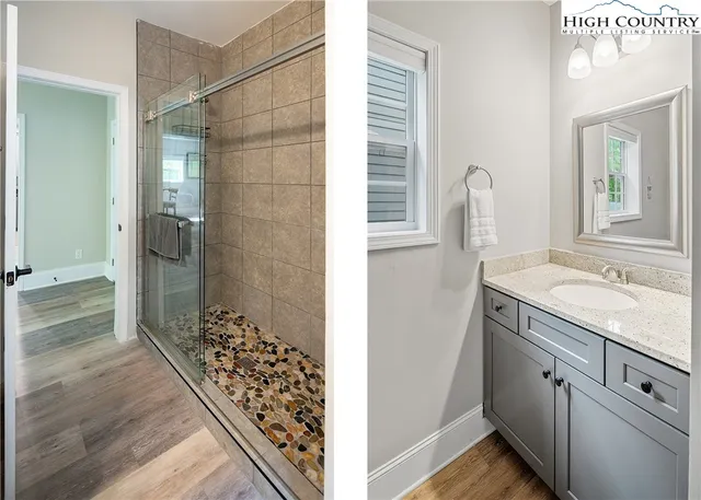 a view of bathroom with shower and mirror