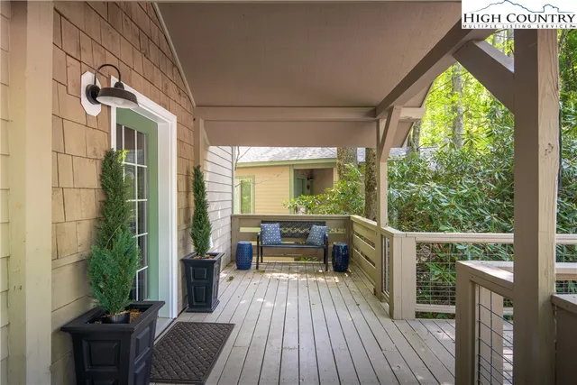 a balcony with furniture and wooden floor