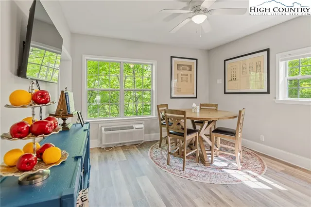 a view of a dining room with furniture and wooden floor