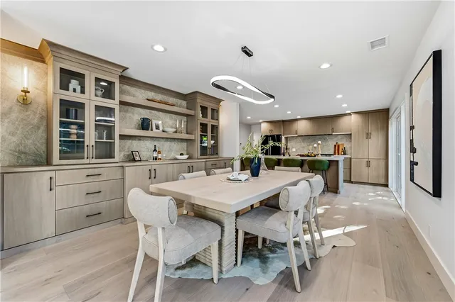 a kitchen with stainless steel appliances kitchen island granite countertop a refrigerator and a sink