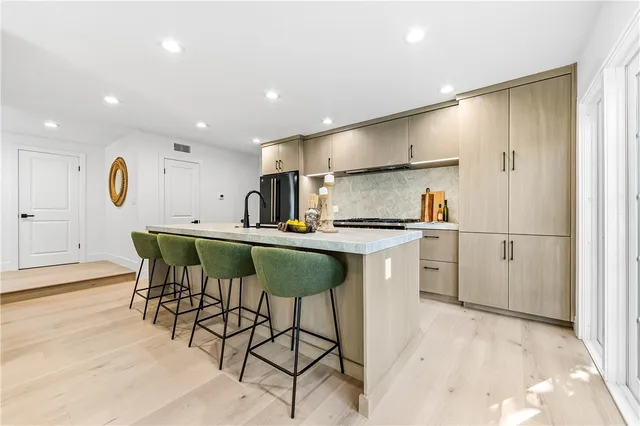 a kitchen with sink stove and refrigerator