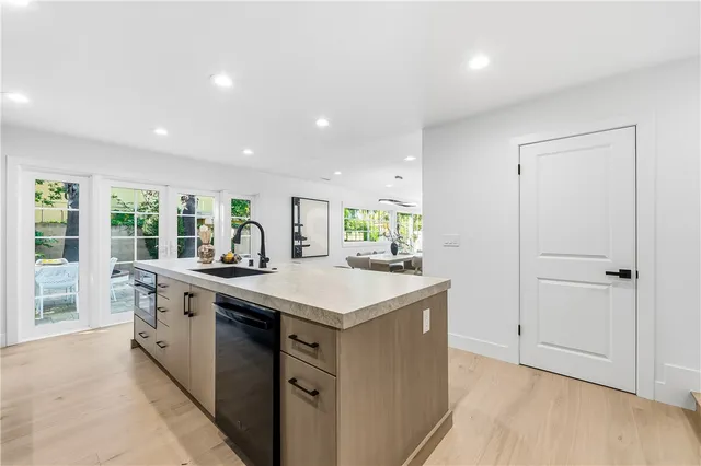 a large kitchen with stainless steel appliances granite countertop a lot of counter space
