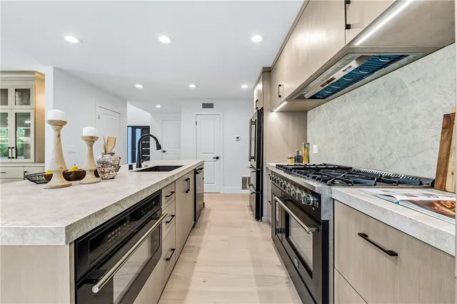 a kitchen with stainless steel appliances a sink and a refrigerator