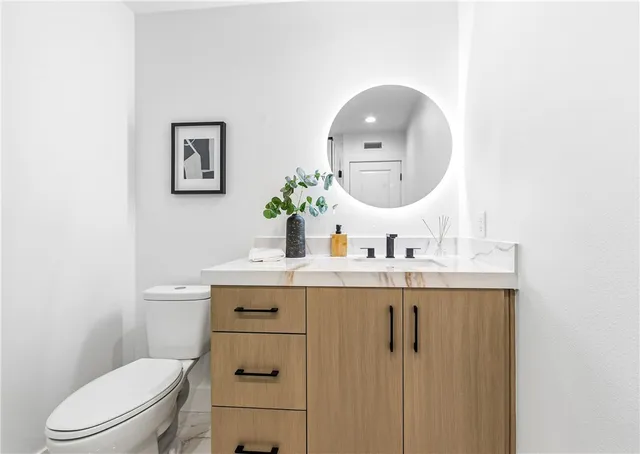 a bedroom with bed and a potted plant next to a window