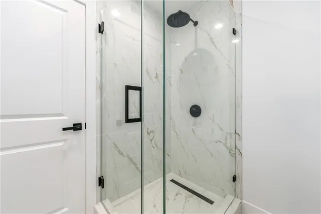 a bedroom with bed and a chandelier