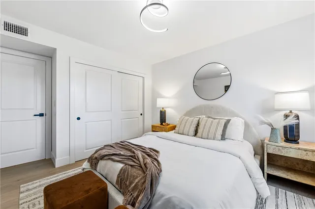 a bedroom with furniture and a large window