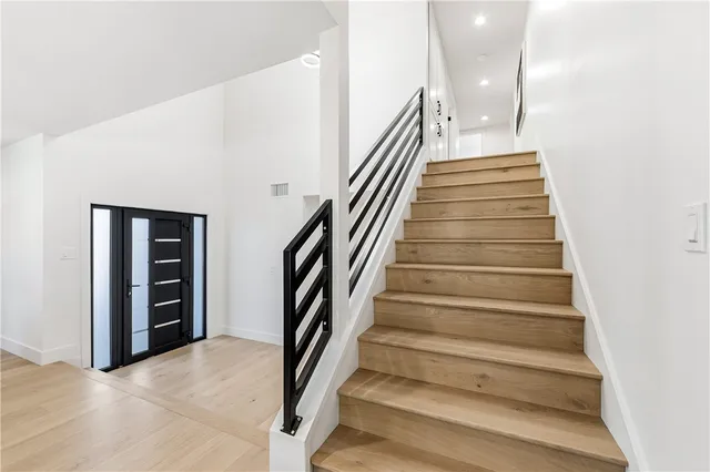 a bedroom with a large bed and a potted plant