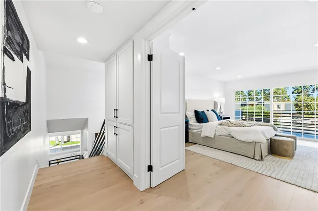 a living room with a bed furniture and a large window