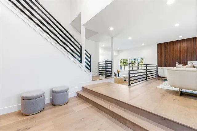 a view of a room with wooden floor stairs and windows