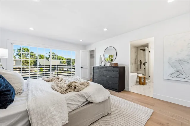 a view of a room with wooden floor and white walls