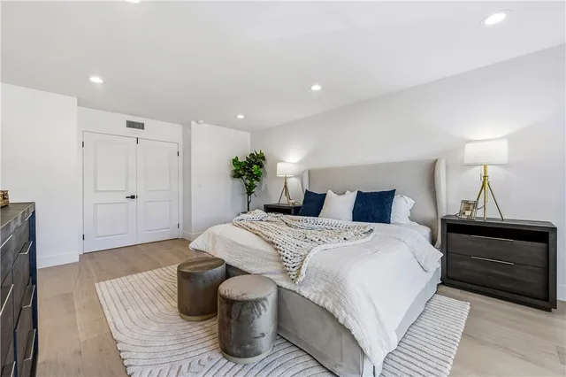 a spacious bathroom with a tub a double vanity sink and a mirror
