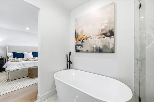 a bedroom with a bed and a night stand