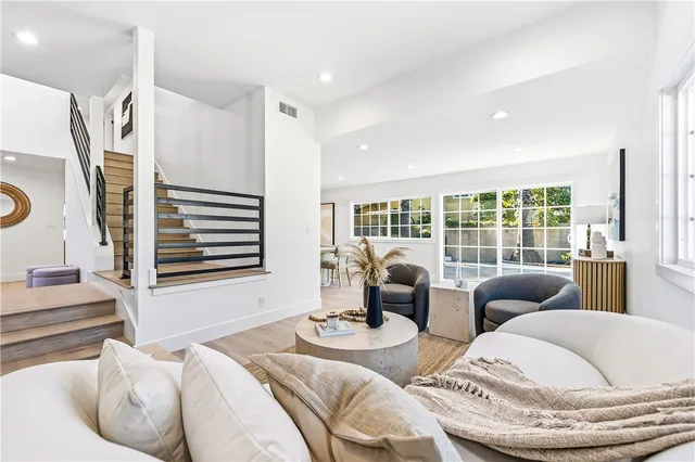 a living room with furniture and kitchen view
