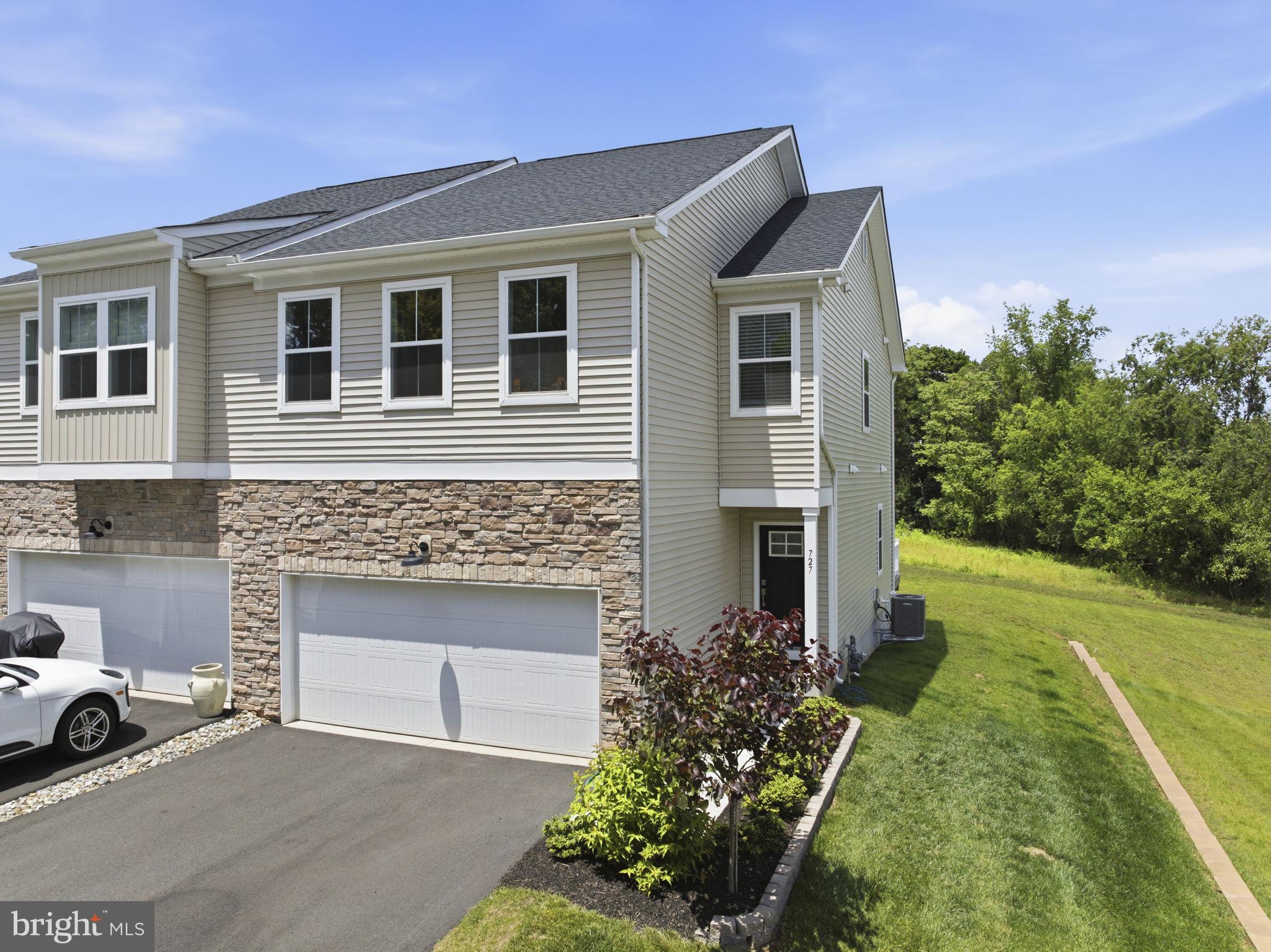 Charming end-unit home with greenery.