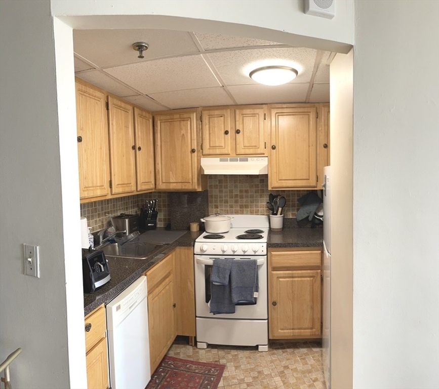 475 Commonwealth Avenue, Unit 601 Boston, MA 02215 - Photo 3 of 13 a kitchen with a sink stove and cabinets