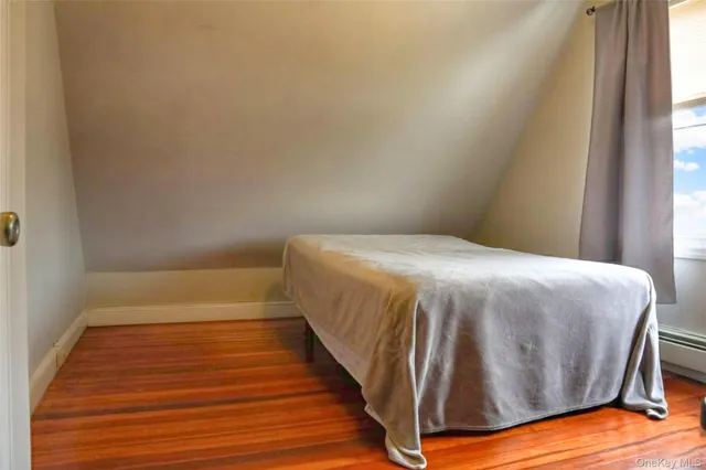 a bed sitting in a bedroom next to a window