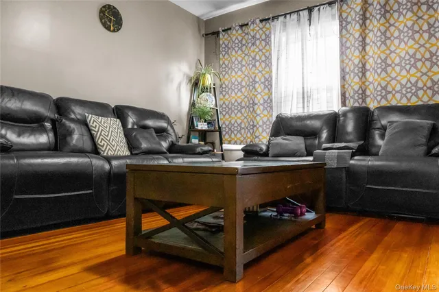 a bed sitting in a bedroom next to a window and a mirror