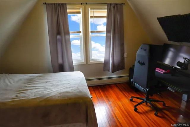 a bedroom with a bed and a flat tv screen