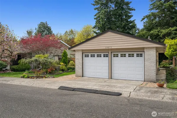 a front view of a house with a yard and garage