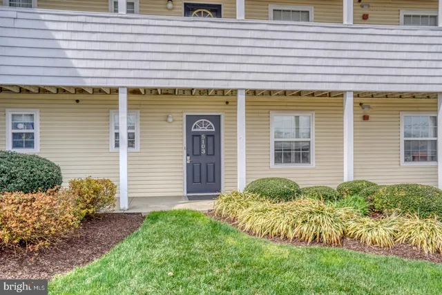 a view of a house with brick walls and a yard