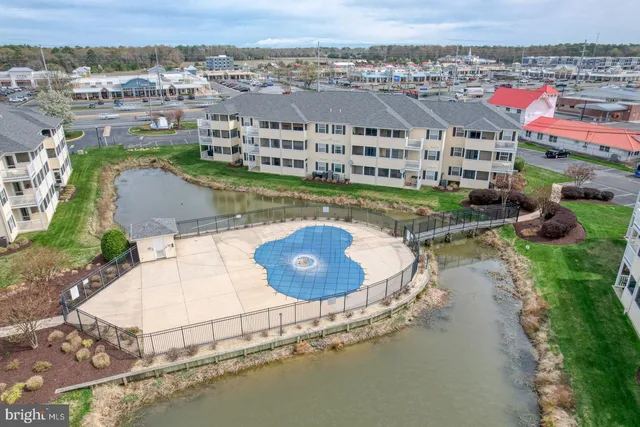 an aerial view of a house with a yard and lake view