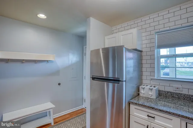a kitchen with a refrigerator and countertop